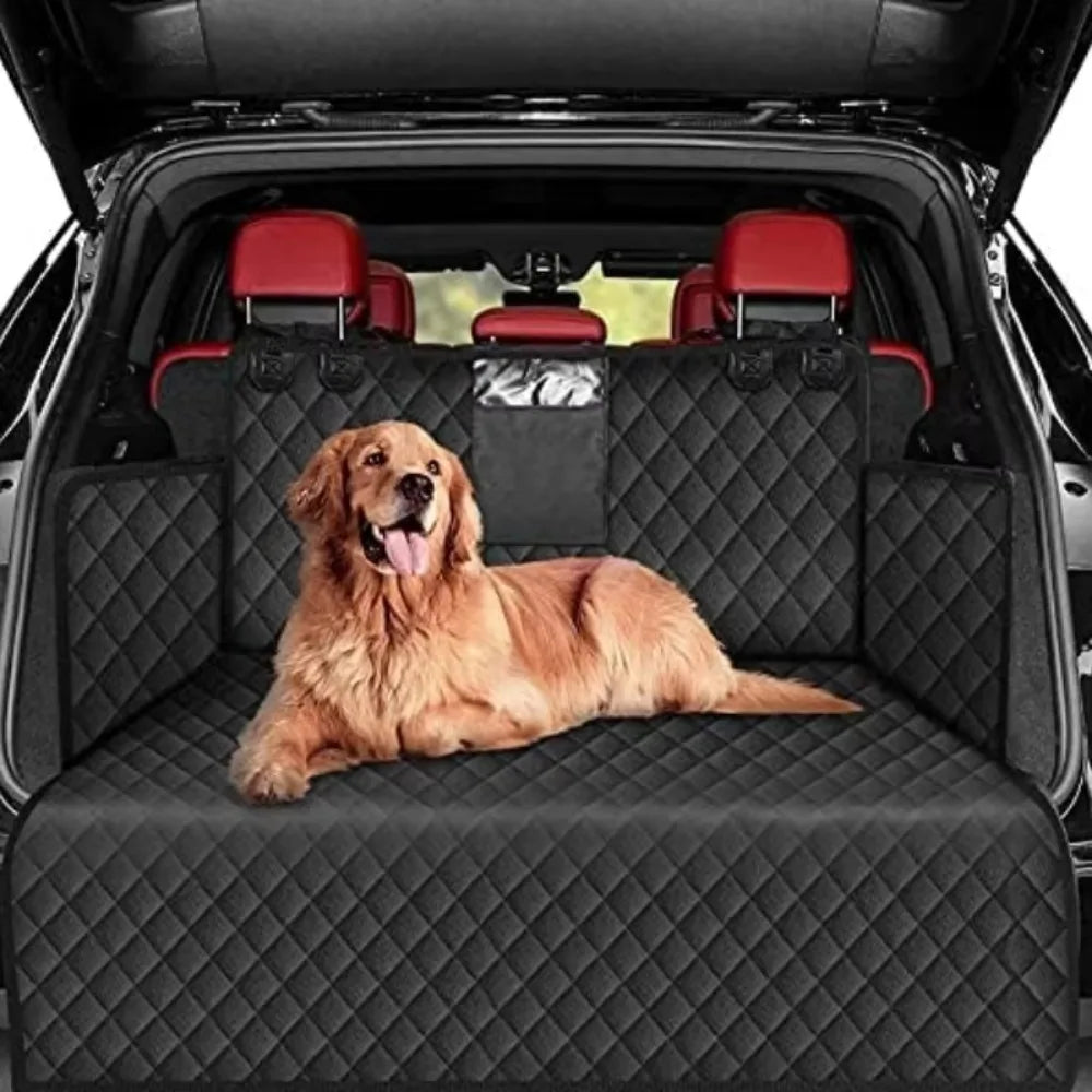 Dog lying on a black quilted car seat cover in a vehicle with red interior.