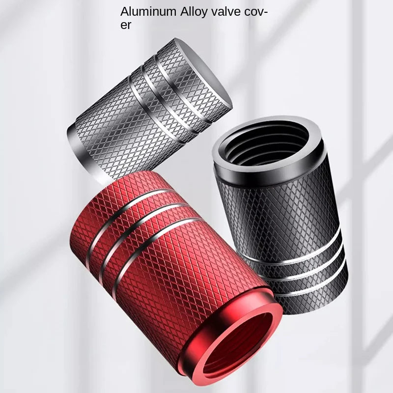 Three metal valve covers in red, black, and silver on a light gray background.