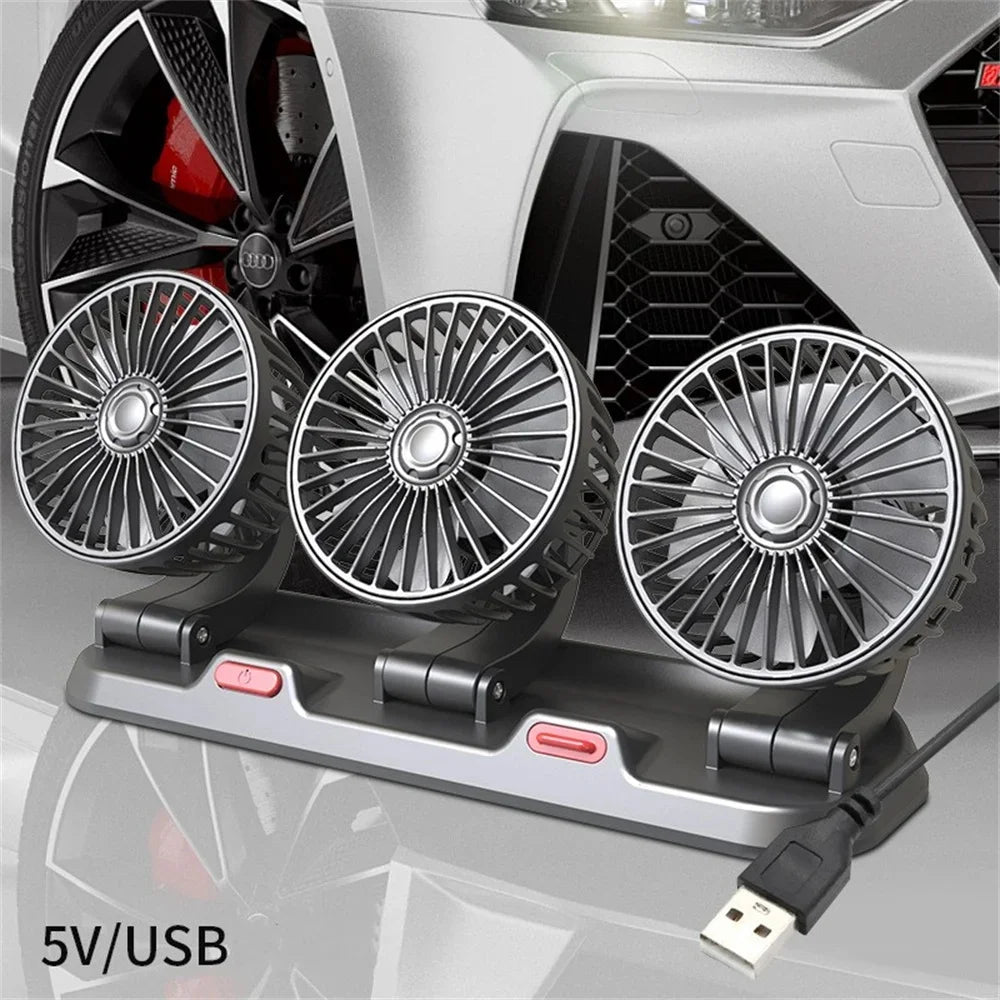 Three USB fans on a car dashboard with a car in the background