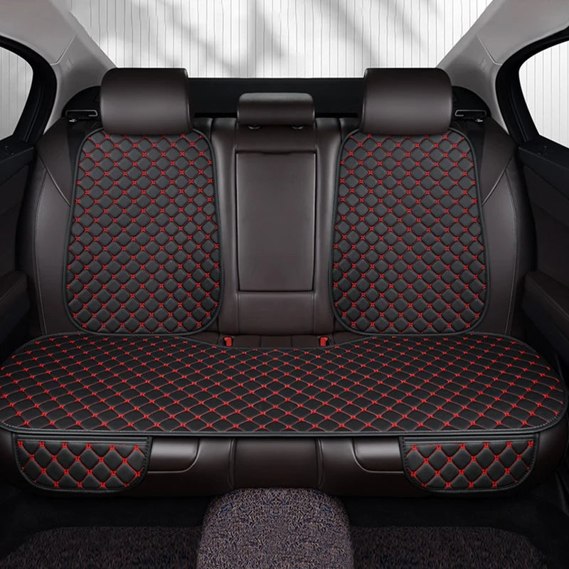 Car seat covers with red stitching on a car interior