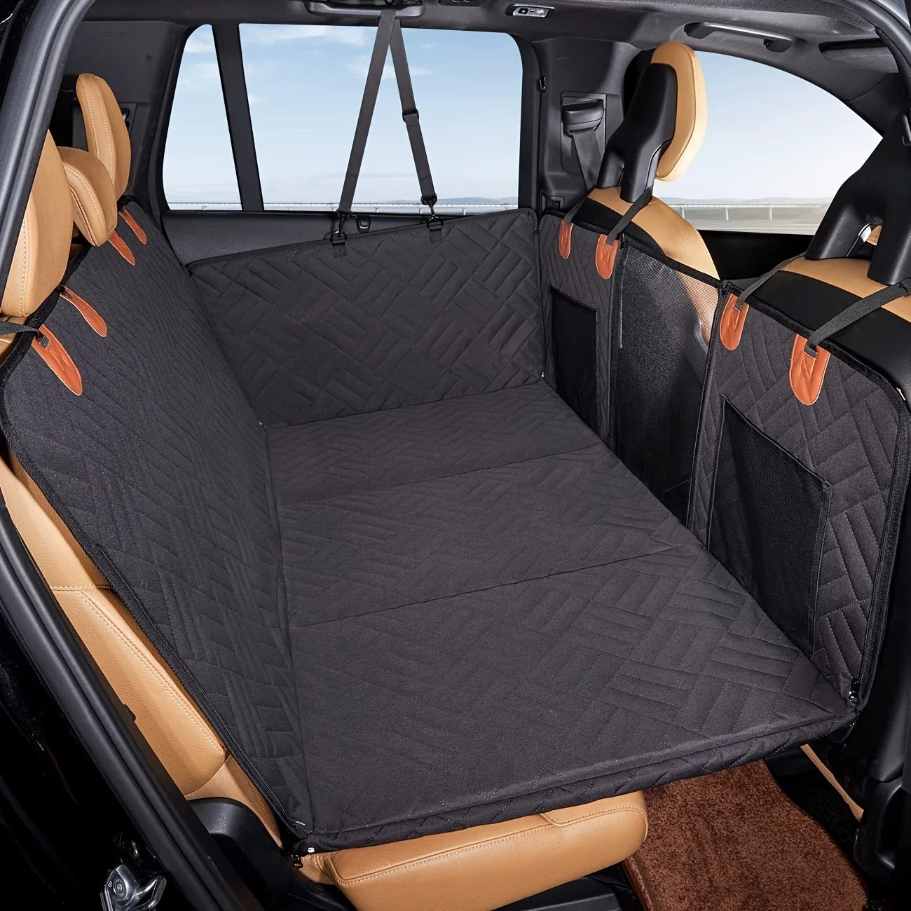 Car interior with a black quilted cargo cover on the floor.