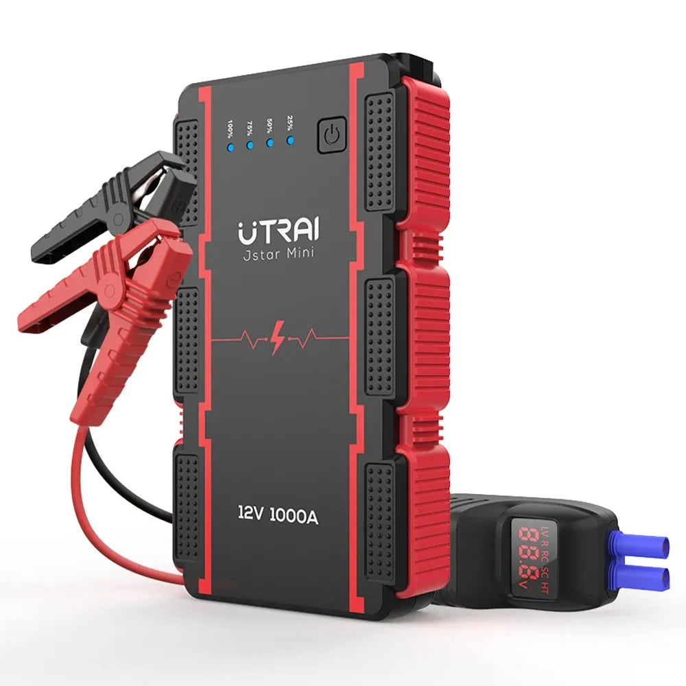Black and red jump starter with clamps and digital display on a white background