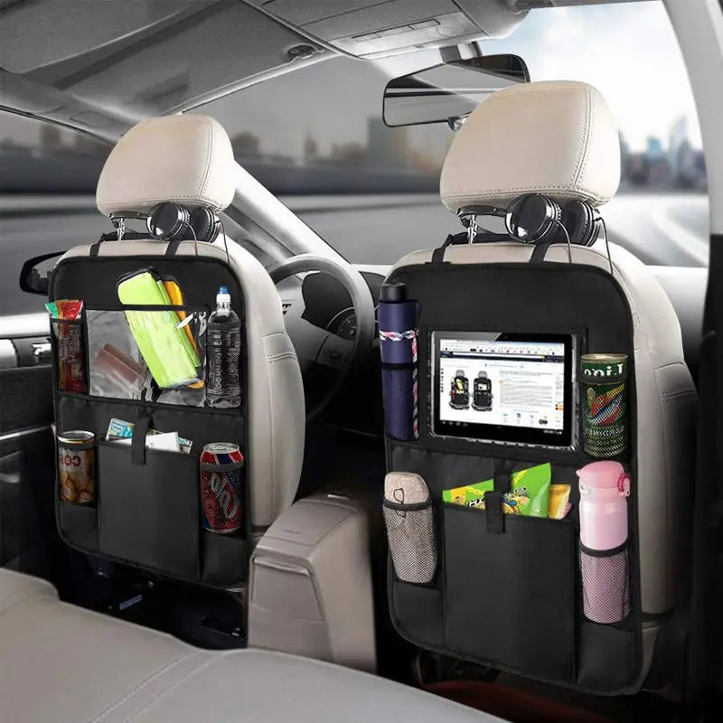 Car seat back organizers with various items in a vehicle interior.