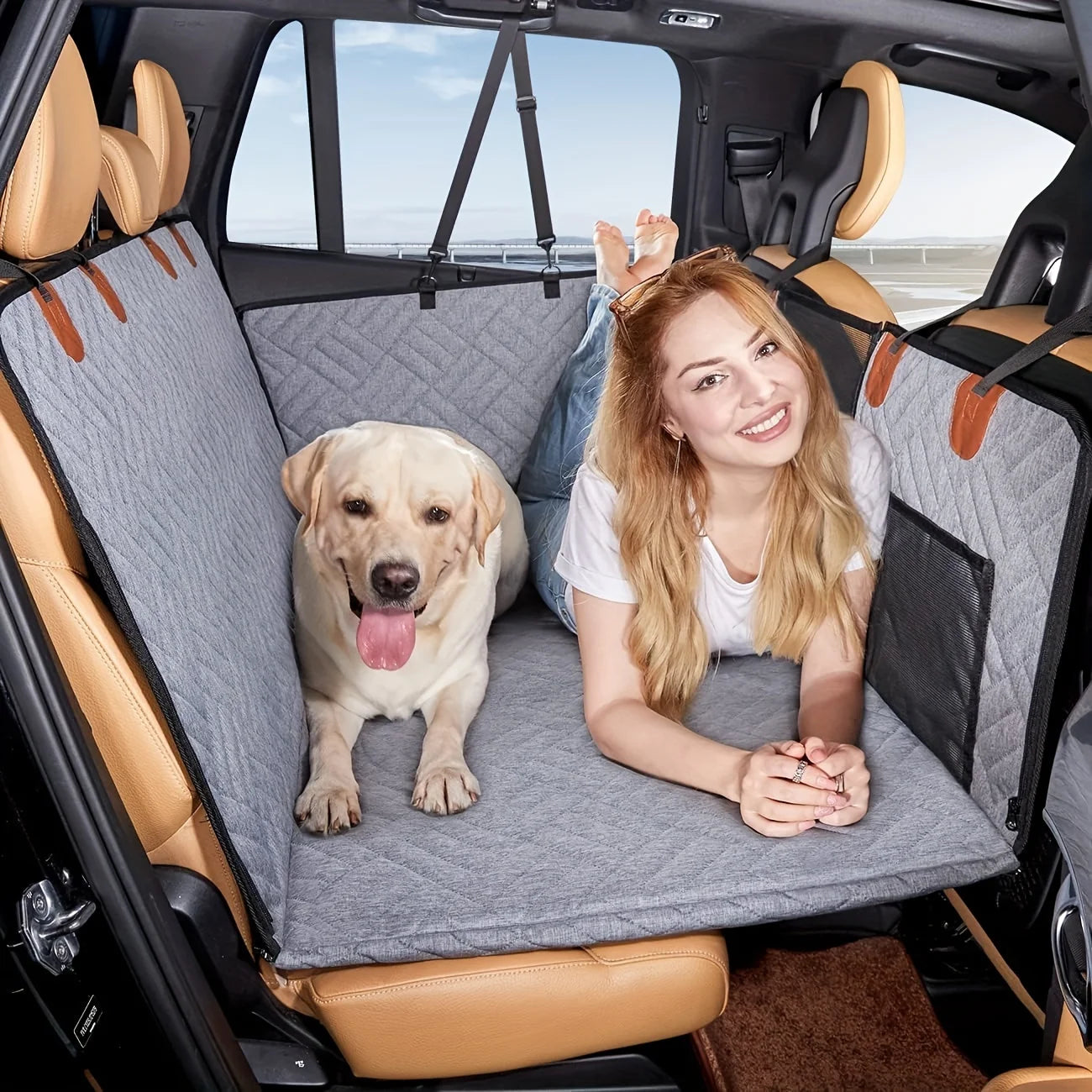 Woman with a dog on a car seat cover in a vehicle