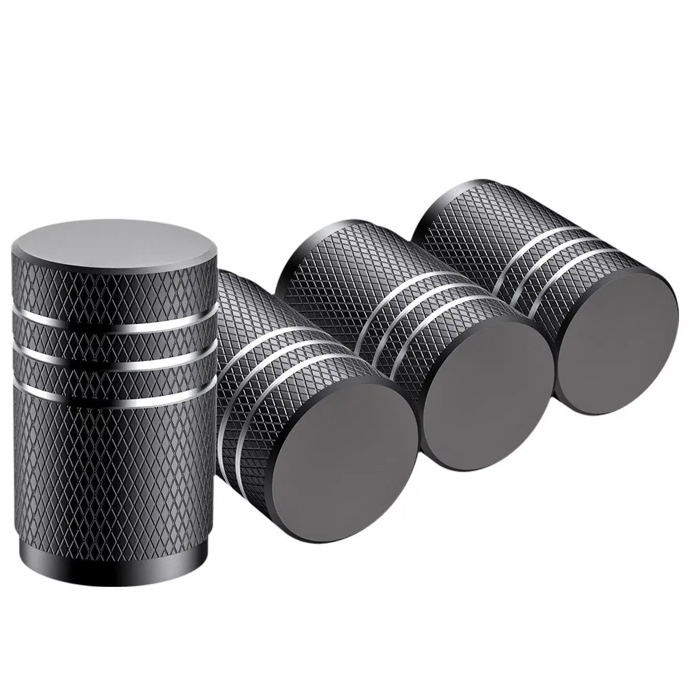 Set of black cylindrical objects with textured surfaces on a white background