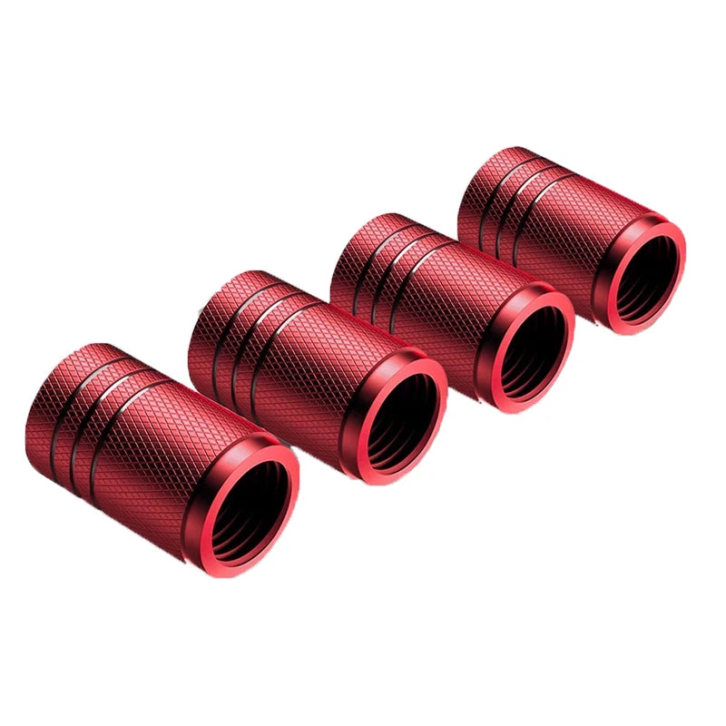 Five red metal valve stem caps on a white background