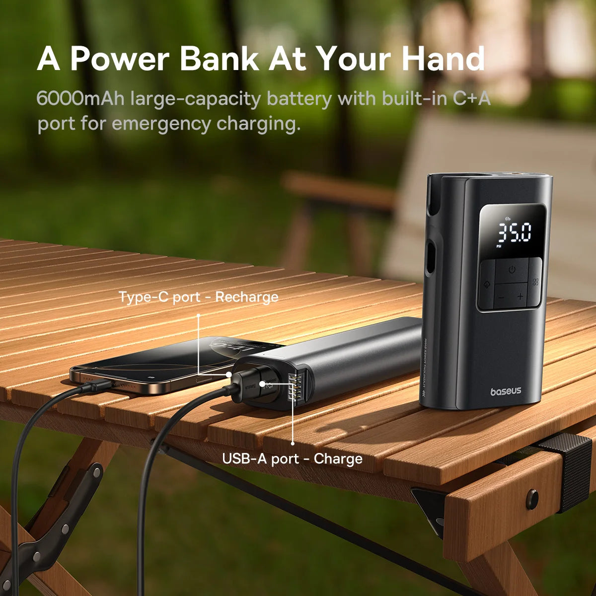 Power bank with smartphone on a wooden table outdoors