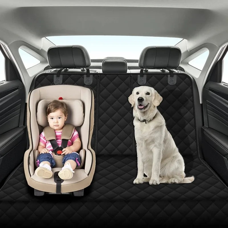 Child in a car seat and dog on a black car mat in a vehicle
