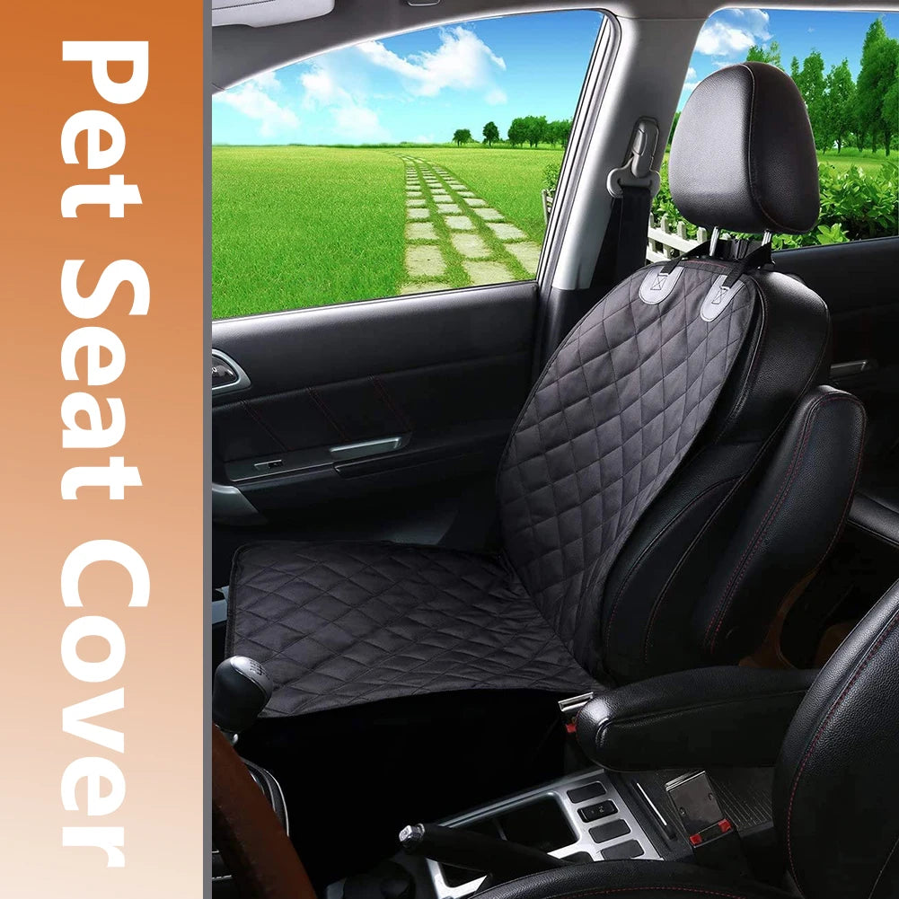 Car interior with a black quilted pet seat cover on the driver's seat, outdoor scenery visible through the window.